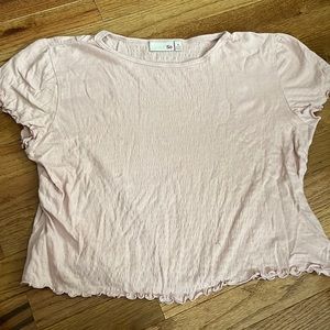This is a pink ruffled shirt, size 14/16.